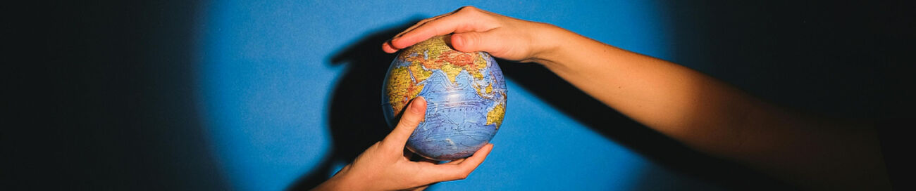 two hands holding a globe